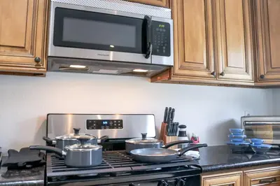 a kitchen with a stove with pots and pans at Fun Family Retreat Games, Massage Chair & Yard in Mission Viejo