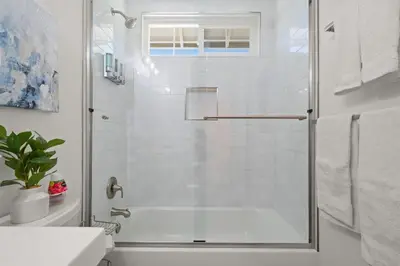 a bathroom with a shower with a glass door at Fun Family Retreat Games, Massage Chair & Yard in Mission Viejo