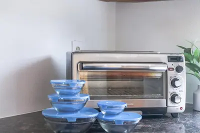 a counter with blue bowls in front of a toaster oven at Fun Family Retreat Games, Massage Chair & Yard in Mission Viejo