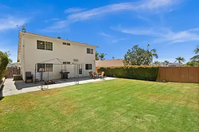 a yard with a white house with a fence at Fun Family Retreat Games, Massage Chair & Yard in Mission Viejo