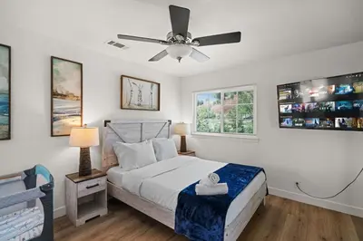 a bedroom with a bed and a ceiling fan at Fun Family Retreat Games, Massage Chair & Yard in Mission Viejo