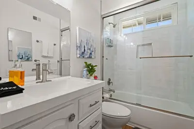 a white bathroom with a sink and a toilet at Fun Family Retreat Games, Massage Chair & Yard in Mission Viejo