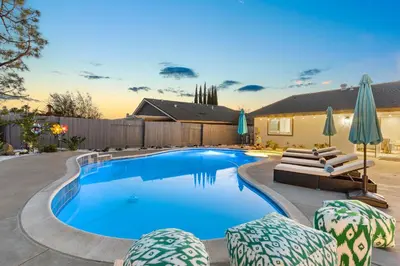 a swimming pool with lounge chairs and umbrellas at Upscale Resort House, Views, Saltwater Pool, Spa in Spring Valley