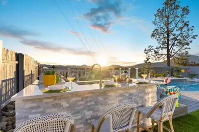 a patio with a table and chairs and a pool at Upscale Resort House, Views, Saltwater Pool, Spa in Spring Valley