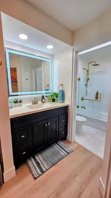a bathroom with a sink and a mirror and a toilet at Ocean View, Sand, Waves & Wonder in Dana Point