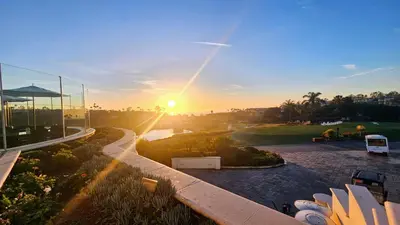 a view of the sunset from the balcony of a building at Ocean View, Sand, Waves & Wonder in Dana Point