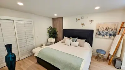 a bedroom with a large bed and a vase at Ocean View, Sand, Waves & Wonder in Dana Point
