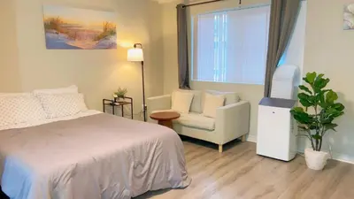 a bedroom with a bed and a chair and a window at Haven Vibe in Escondido