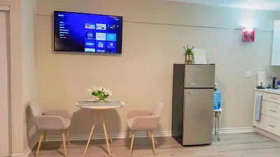 a room with a table and a tv on the wall at Haven Vibe in Escondido