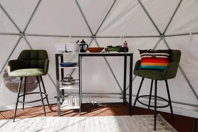two green chairs and a table in a yurt at A Quiet Fireside Retreat in a Scenic Glamping Dome in Fallbrook
