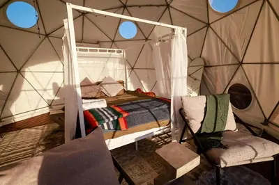 a bedroom with a bed in a tent at A Quiet Fireside Retreat in a Scenic Glamping Dome in Fallbrook