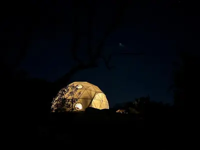 a lit up igloo in the dark at night at A Cozy Fireside Glamping Escape with Ridge Views in Fallbrook