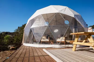 a tent on a wooden deck with a picnic table at Cozy Dome Hideaway with Sweeping Sunrise View in Fallbrook