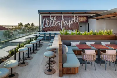 a restaurant with tables and chairs on a roof at The Bower Coronado in San Diego