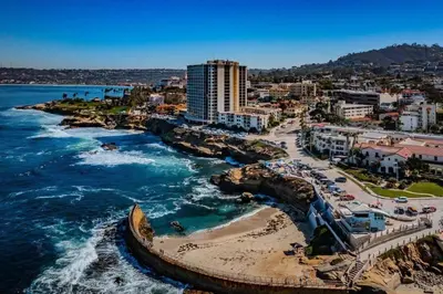 an aerial view of a beach with buildings and the ocean at Top Floor Oceanfront Condo in San Diego