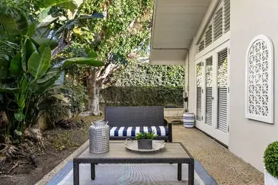 a patio with a coffee table and a chair at Classic Cottage in the Heart of La Jolla Shores in San Diego
