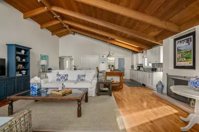 a living room with a white couch and a table at Classic Cottage in the Heart of La Jolla Shores in San Diego