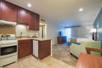 a kitchen and living room with a bed in a room at Winners Circle Resort in Solana Beach