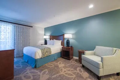 a hotel room with a bed and a chair at Winners Circle Resort in Solana Beach