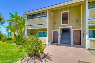 a house with two doors and a yard at Entire Private Home with 3 Bedrooms 2 Bathrooms, Family Home Free Pool, Tub and Parking, Available Now in Chula Vista