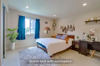 a bedroom with a bed with blue curtains and a desk at Entire Private Home with 3 Bedrooms 2 Bathrooms, Family Home Free Pool, Tub and Parking, Available Now in Chula Vista