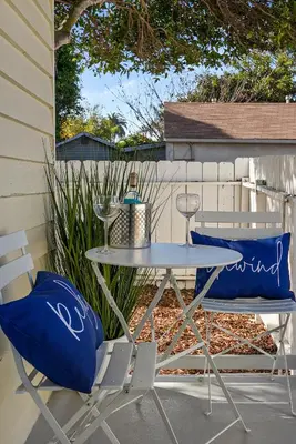 a table and two chairs with blue pillows on a patio at Draper Bungalow By CoastVH - Charming 1940 in San Diego
