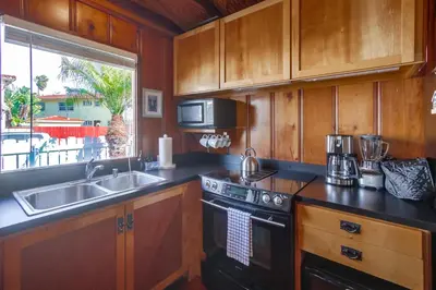 a kitchen with a sink and a stove at Surf Cottage 2 in San Diego