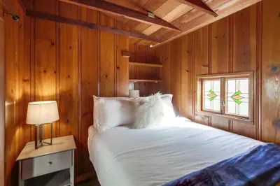 a bedroom with a white bed and a window at Surf Cottage 2 in San Diego