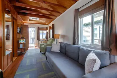 a living room with a couch and a window at Surf Cottage 2 in San Diego