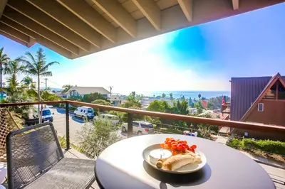 a plate of food on a table on a balcony at Cardiff View in Cardiff-by-the-Sea