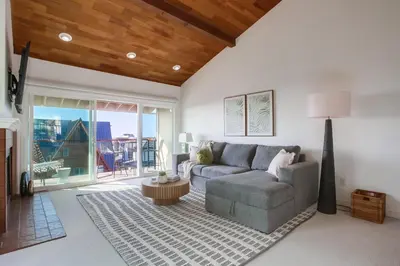a living room with a couch and a table at Cardiff View in Cardiff-by-the-Sea