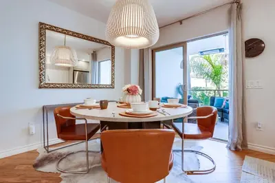 a dining room with a table and chairs and a mirror at Marine Dream in San Diego