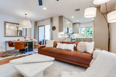 a living room with a brown couch and a kitchen at Marine Dream in San Diego
