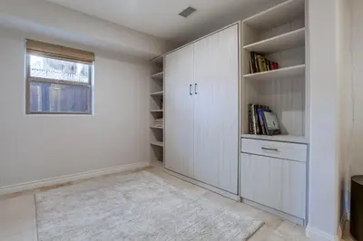 a home office with white cabinets and a window at Marine Dream in San Diego