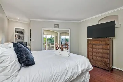 a bedroom with a large bed and a flat screen tv at La Costa Condo Pool BBQ Gated Parking in Carlsbad