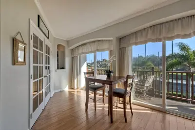 a dining room with a table and a balcony at La Costa Condo Pool BBQ Gated Parking in Carlsbad