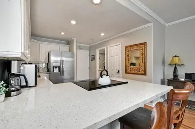 a kitchen with a counter top and a refrigerator at La Costa Condo Pool BBQ Gated Parking in Carlsbad