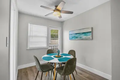 a dining room with a table and chairs and a ceiling fan at 500 ft to Ocean Relaxing stay Parking WiFi 834 in San Diego