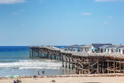 a pier with houses and people on the beach at 500 ft to Ocean Relaxing stay Parking WiFi 834 in San Diego