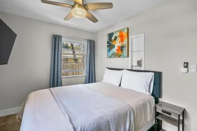 a bedroom with a bed and a ceiling fan at 500 ft to Ocean Relaxing stay Parking WiFi 834 in San Diego