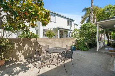 a patio with a table and chairs in front of a house at 500 ft to Ocean Relaxing stay Parking WiFi 834 in San Diego