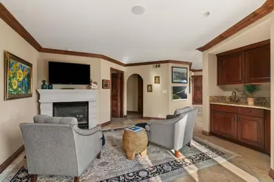 a living room with two chairs and a fireplace at Grand Retreat Rooftop Bliss and Ocean Views in San Diego