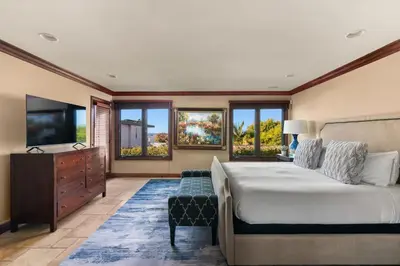 a bedroom with a bed and a flat screen tv at Grand Retreat Rooftop Bliss and Ocean Views in San Diego