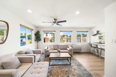 a living room with two couches and a table at Parkside Paradise in San Diego