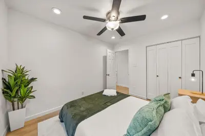 a bedroom with a bed and a ceiling fan at Parkside Paradise in San Diego