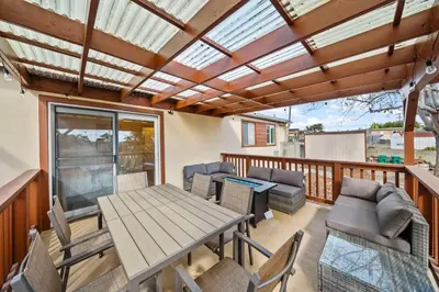 a deck with a wooden table and chairs and a wooden ceiling at Parkside Paradise in San Diego