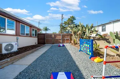 a backyard with a playground and a house at Parkside Paradise in San Diego
