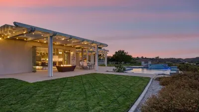 a backyard of a home with a patio with a lawn at Summit Ranch by AvantStay Infinity Pool Views in Temecula