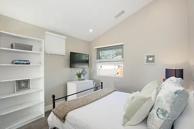 a bedroom with a bed and a television in it at New with Panoramic View in Sunset Cliffs in San Diego
