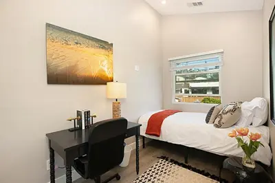 a bedroom with a desk and a bed and a window at New with Panoramic View in Sunset Cliffs in San Diego